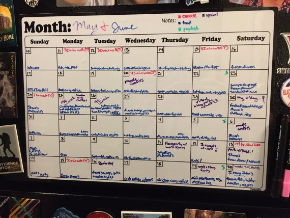 A whiteboard calendar starting May 10 and ending June 20 with entries color-coded for exercise, food, paycheck, and "special".